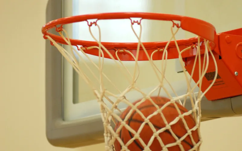 Basketball dropping through a hoop and net
