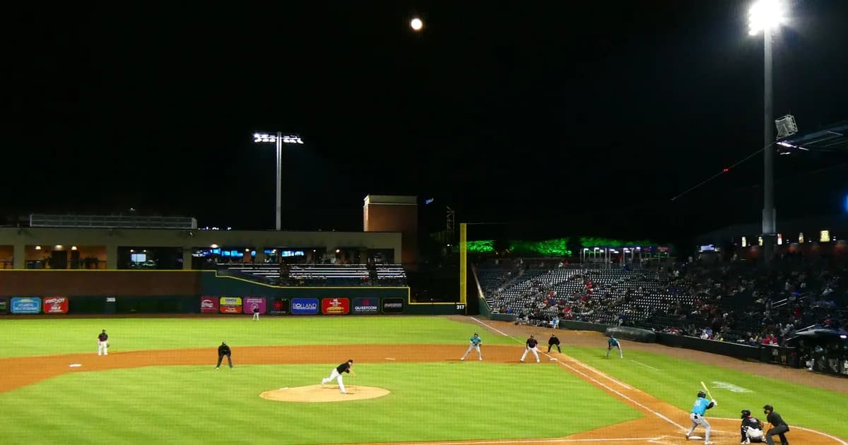 Baseball ballpark under stadium lights during a night game